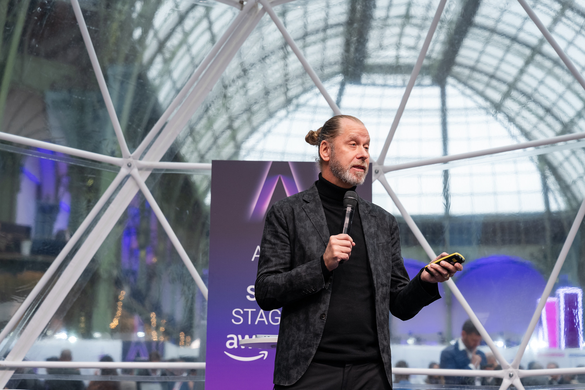Theodore Bergqvist speaking on stage at Adopt AI in the Grand Palais